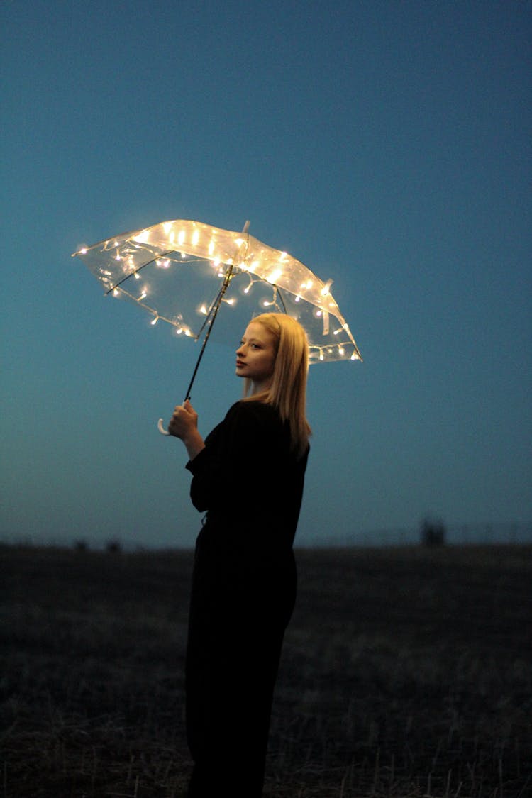 Woman Holding An Illuminated Umbrella