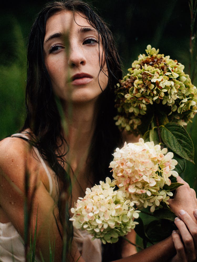 Brunette Woman Holding Flowers