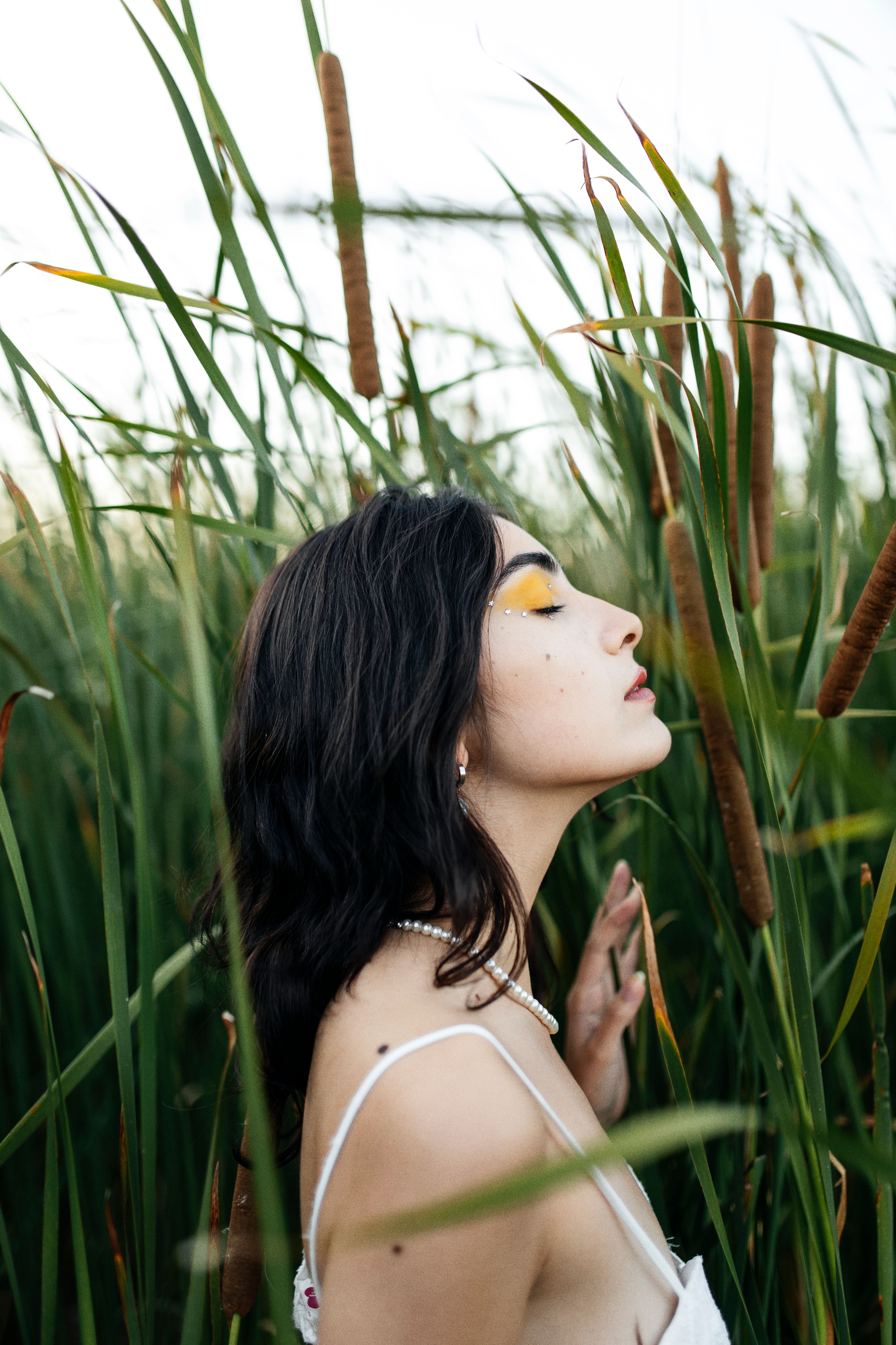 Young Woman in a White Dress Standing on a Field with High Grass · Free ...