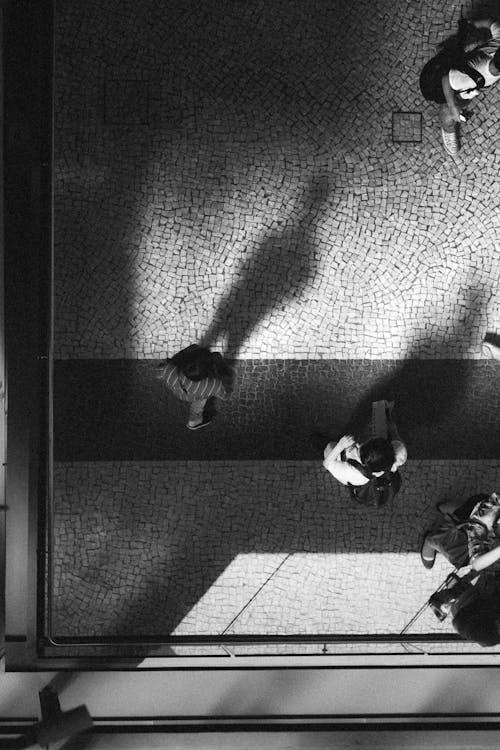 Monochrome Photo of People Walking on the Road