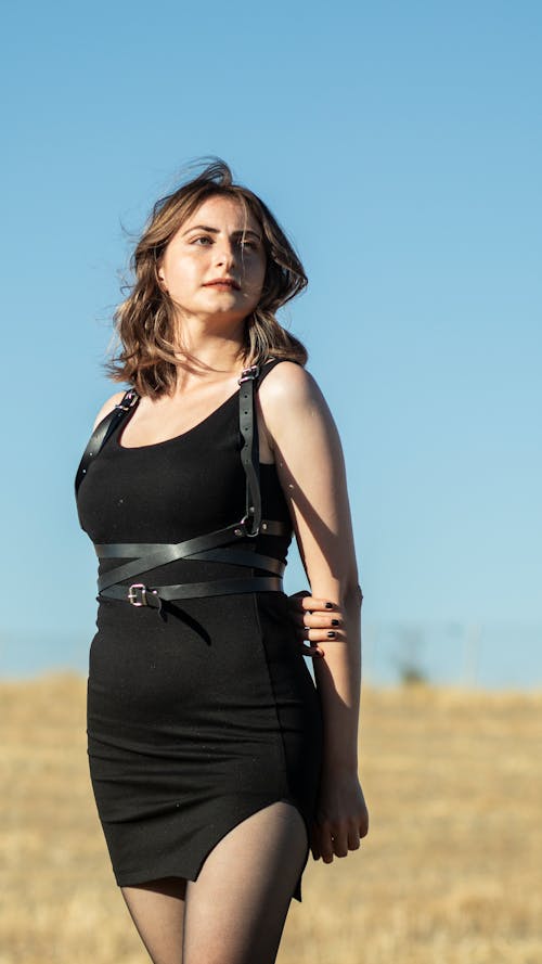 Model in a Black Mini Dress with a Harness of Leather Belts