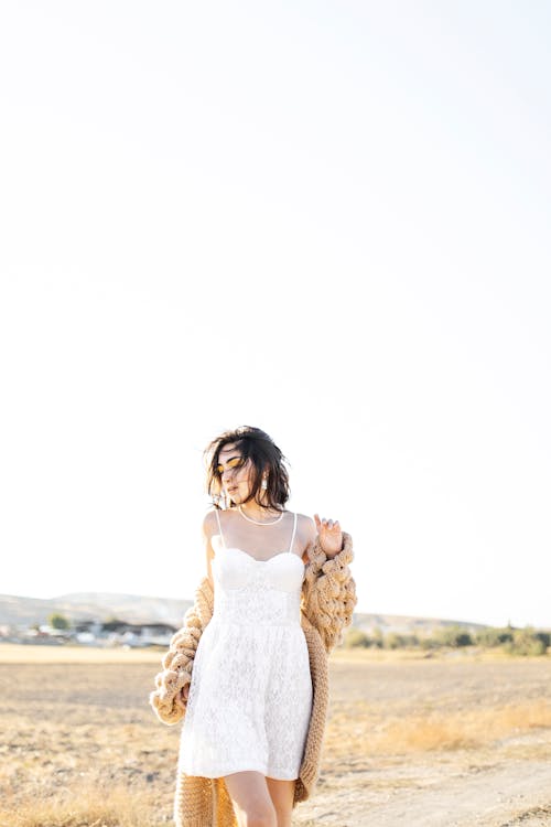 Woman Wearing White Dress Posing on a Field