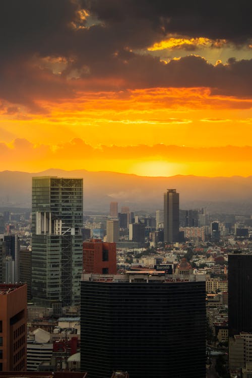 Free Cityscape and a Dramatic Yellow Sky at Sunrise Stock Photo