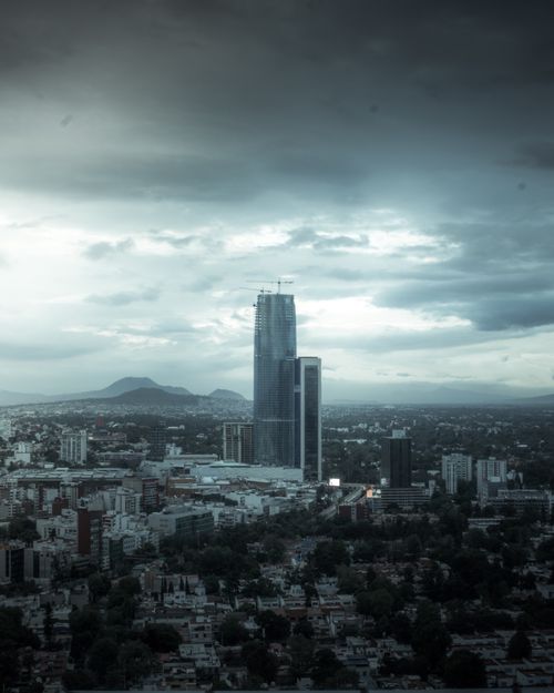 Free A dramatic dawn skyline of Ciudad de México, showcasing towering skyscrapers under a moody, overcast sky. Stock Photo
