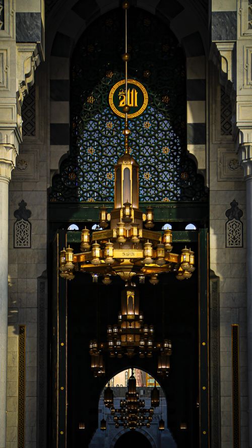 Free Elegant chandelier and ornate archway in a mosque in Mecca, showcasing intricate Islamic design. Stock Photo