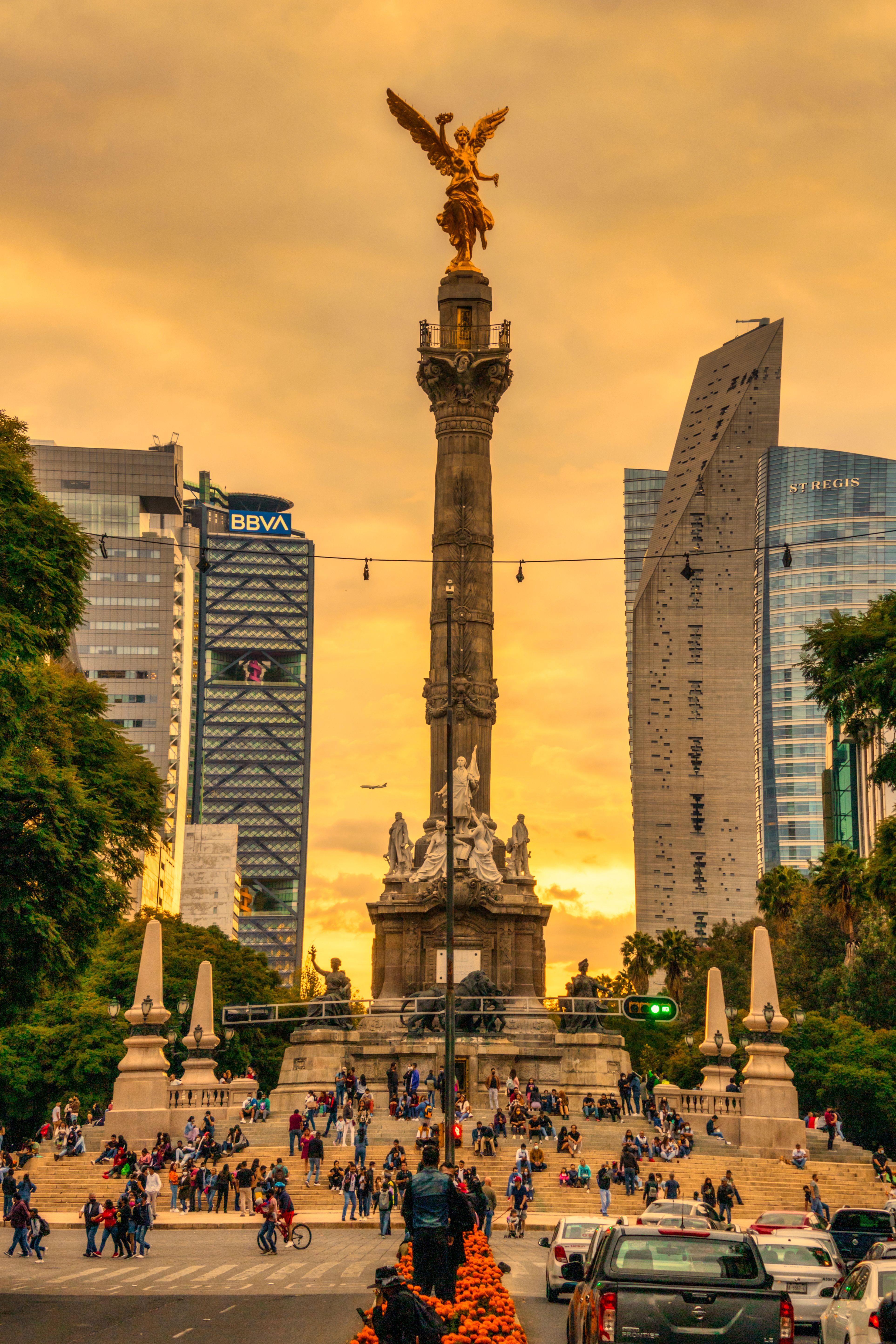 Vibrant view of the Angel of Independence in Mexico City's urban skyline during sunset.