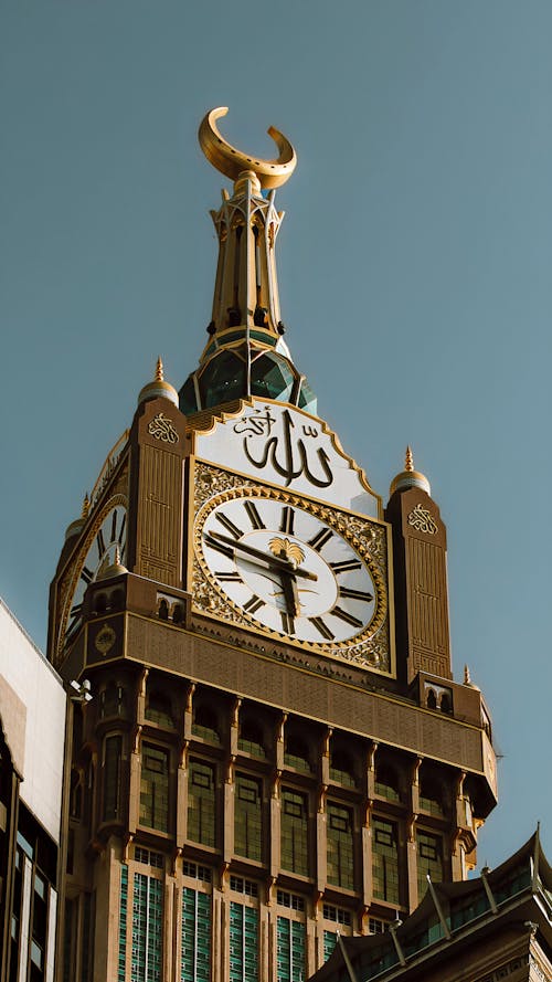 Low Angle Shot of the Mecca Clock Tower with Arabic Script 