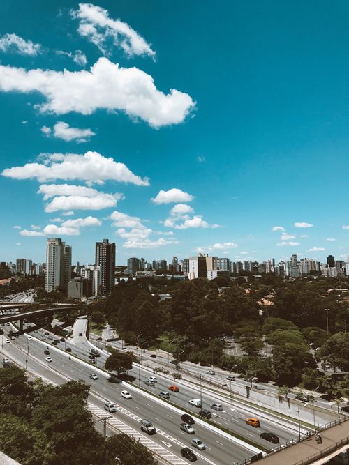 Free Cityscape with busy highway and towering skyscrapers under clear blue sky. Stock Photo