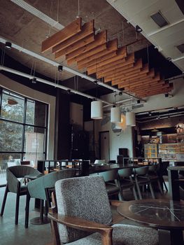Modern cafe with stylish furniture and unique ceiling design in Navi Mumbai, India.