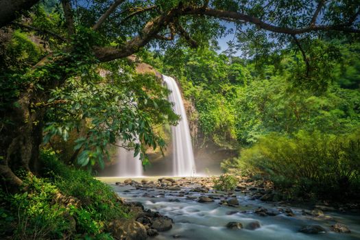 Scenic waterfall enveloped by lush greenery in Sukabumi, Jawa Barat, Indonesia.
