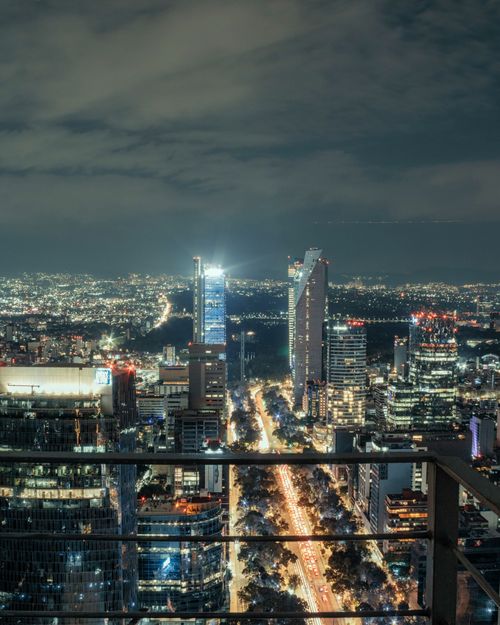 Free Dramatic aerial view of Mexico City's illuminated skyline showcasing modern architecture and vibrant urban life. Stock Photo