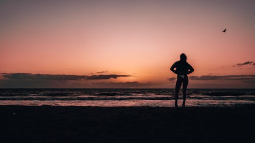 Silhouette of Woman at Beach in the Evening