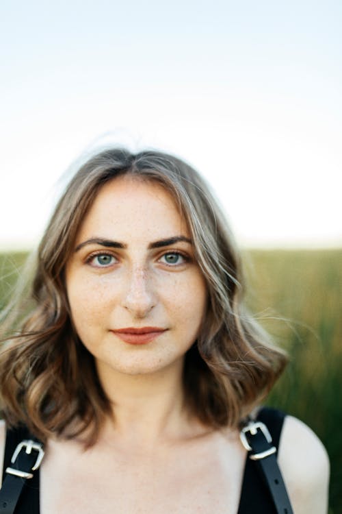 Portrait of Brunette Woman on a Field