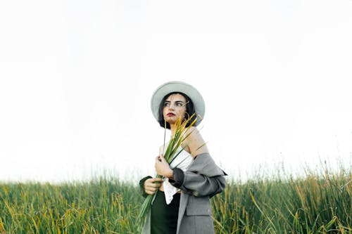 Brunette Wearing Hat and Jacket in Countryside