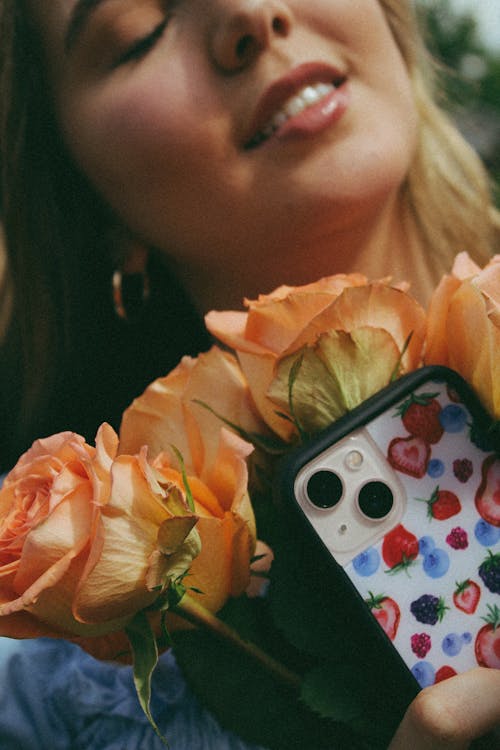 Woman with Flowers and Smartphone
