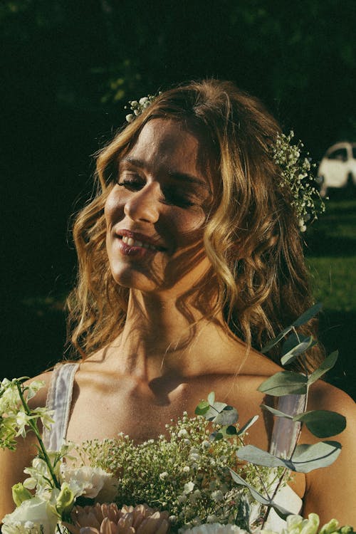 Portrait of Blonde Bride with Bouquet of Flowers