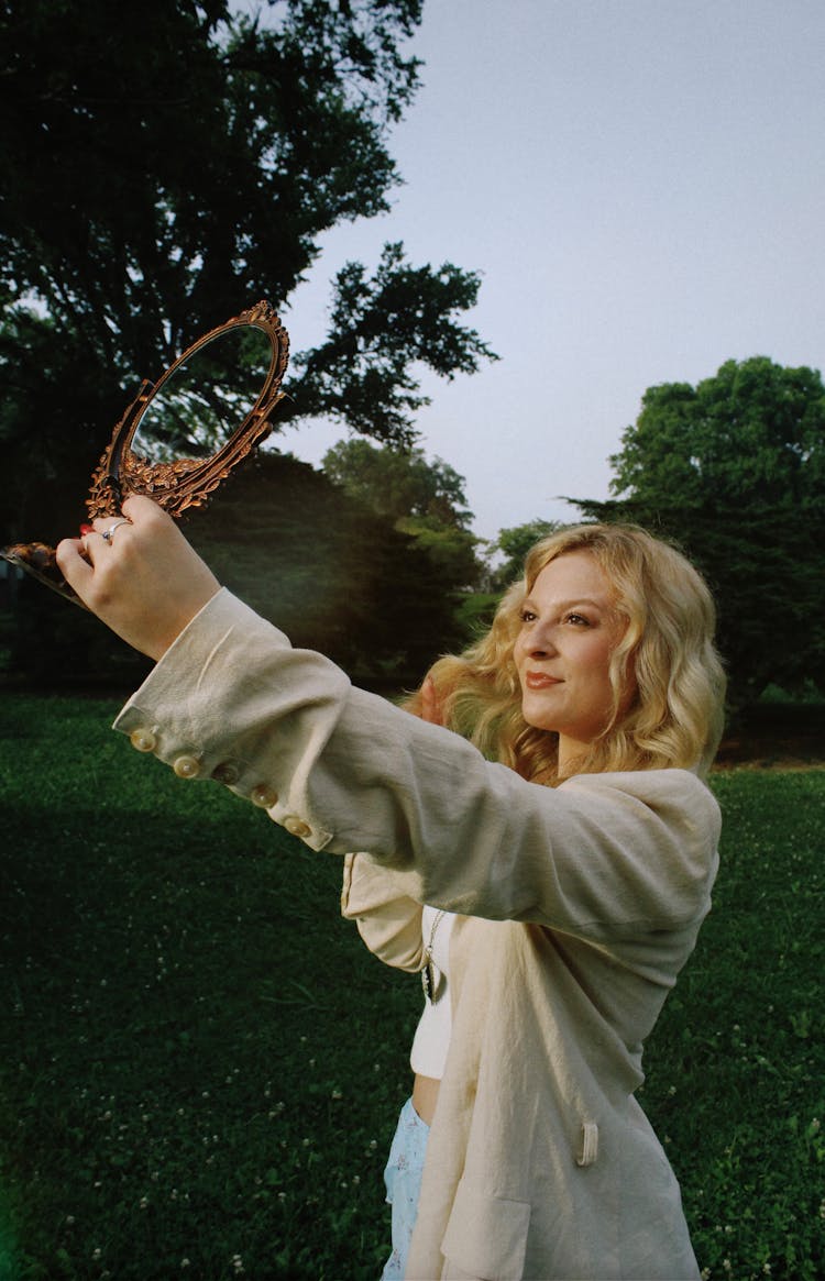 Blonde Woman Looking In A Mirror