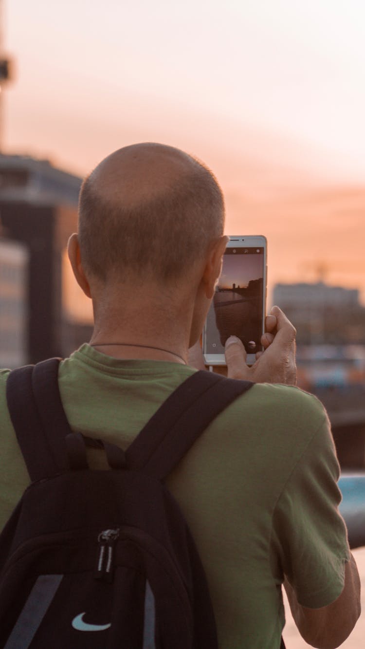 Bald Man Taking A Picture