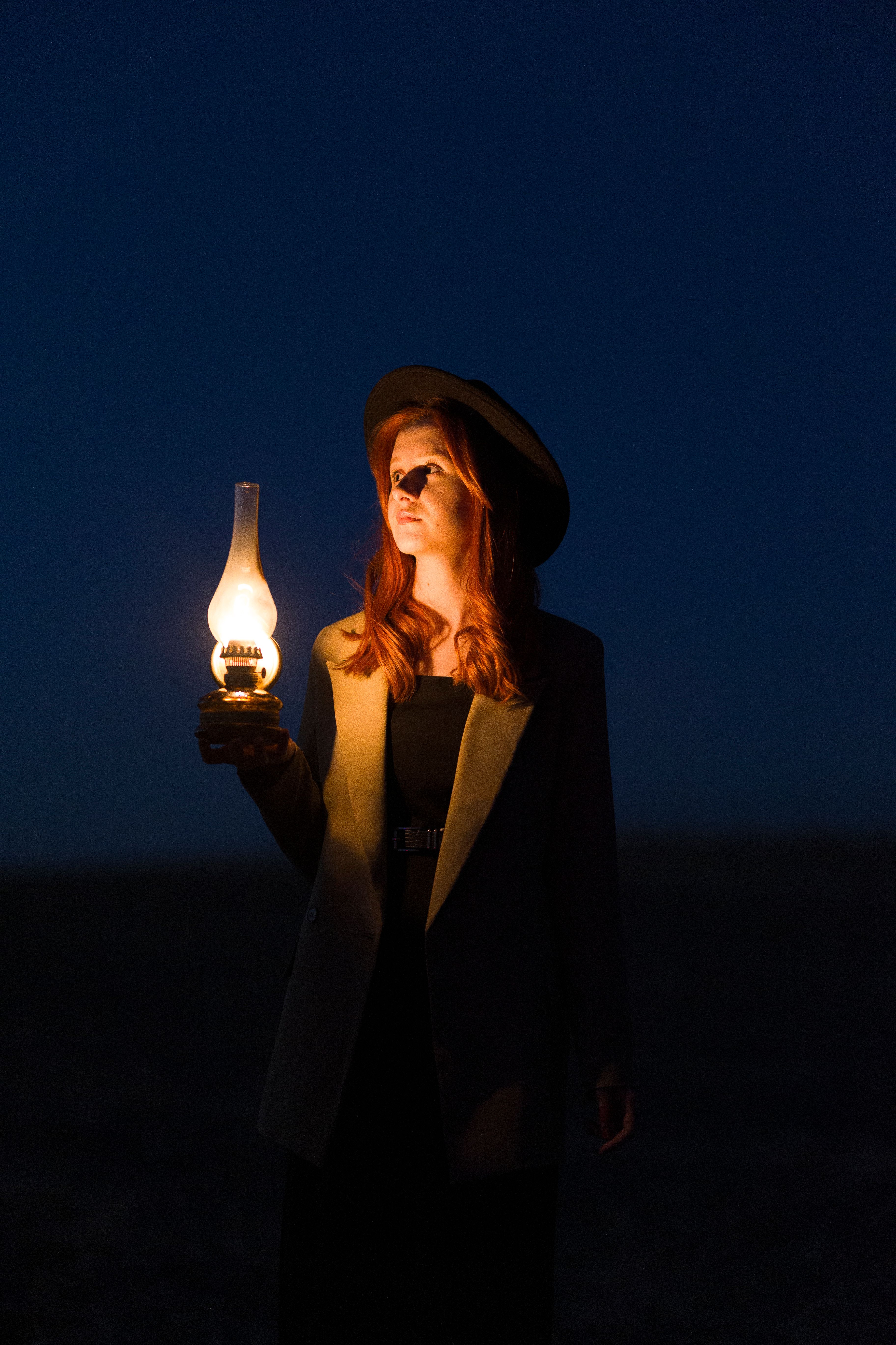 Woman Holding a Lantern in the Dark · Free Stock Photo