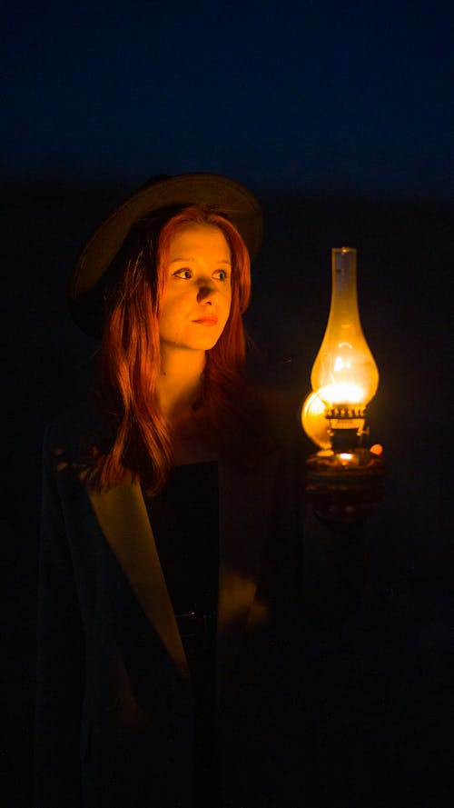 Woman with Lamp in Night Darkness