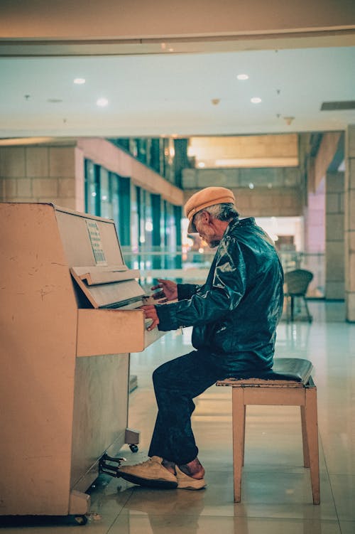 Elderly Man Sitting and Playing Piano