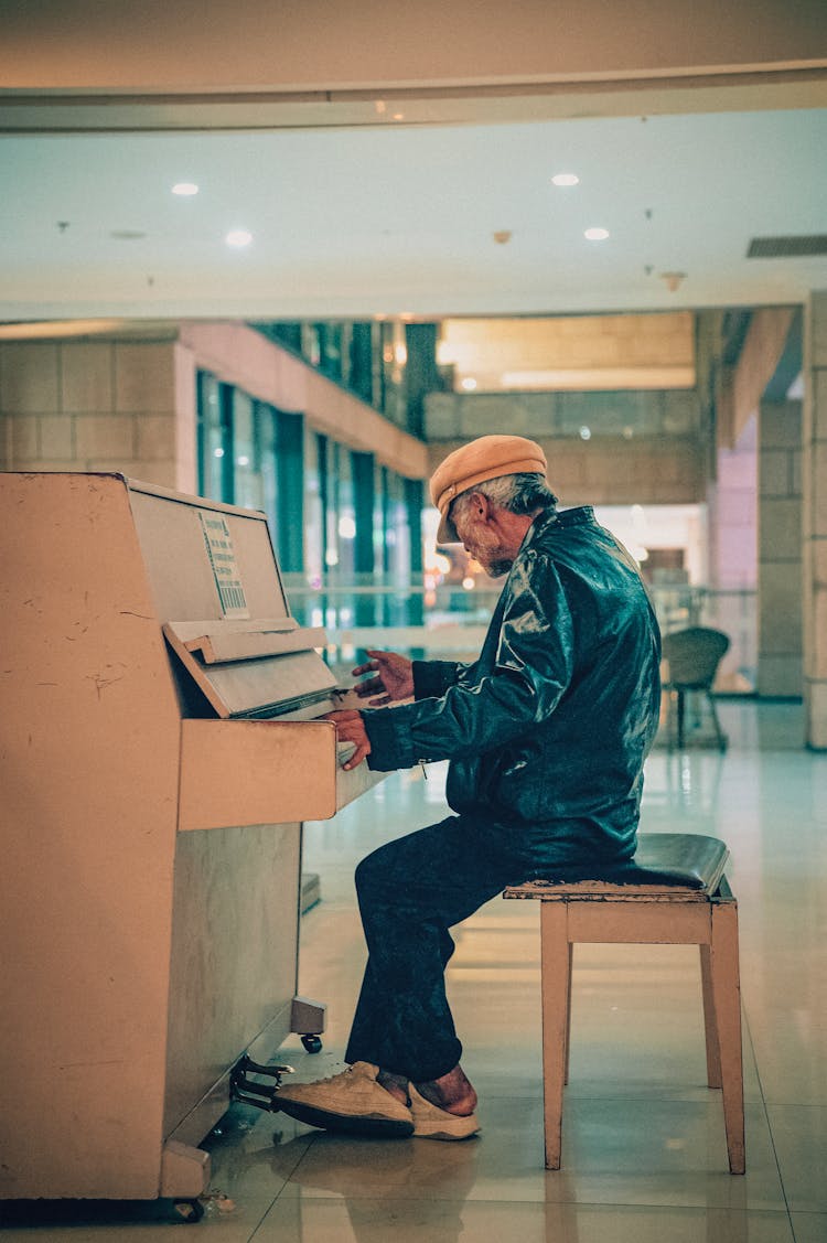 Elderly Man Sitting And Playing Piano