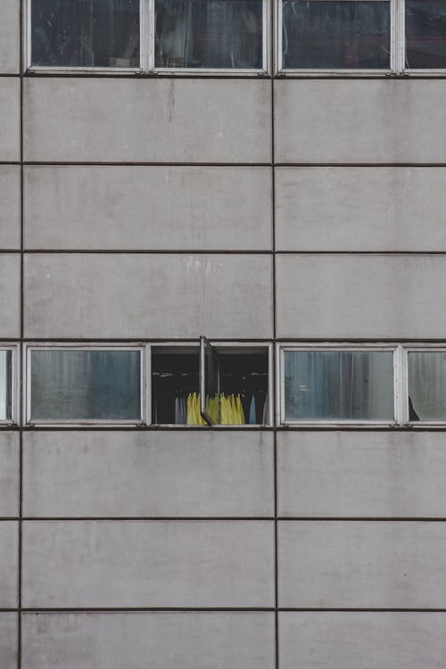 Open Window in a Grey Concrete Building Wall