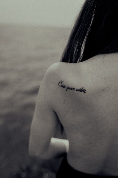A woman with a tattoo on her back that says, you are the one