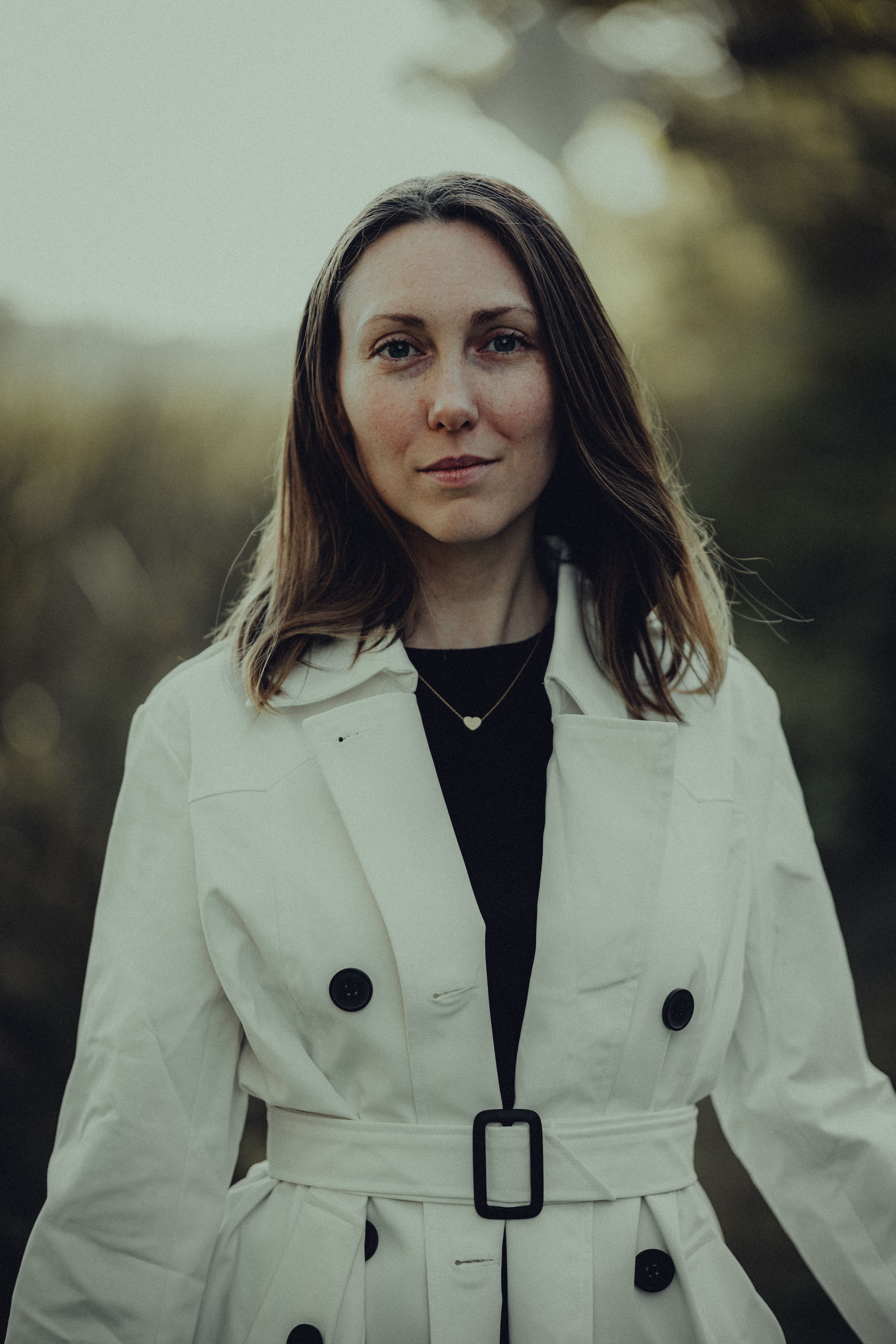 Woman in a Trench Coat Standing Outside · Free Stock Photo