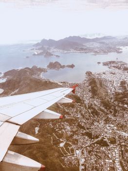 Scenic aerial view from airplane over Rio de Janeiro with coastline and mountains.