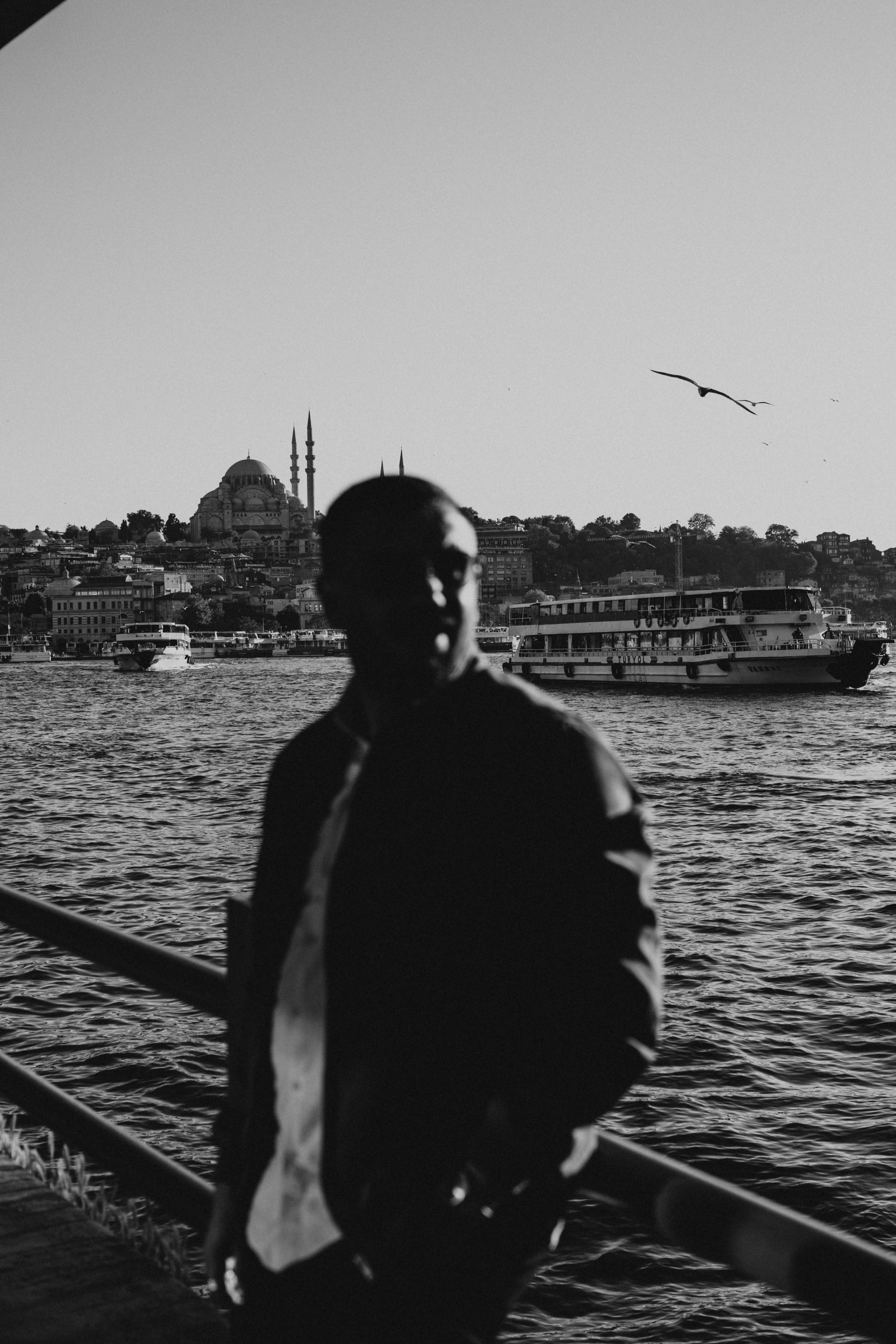 a man standing on a pier in front of a boat