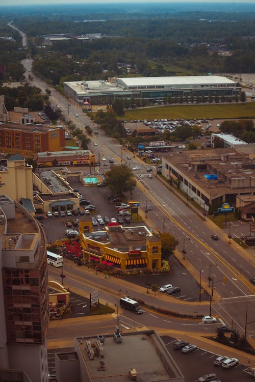 An aerial view of a city street with cars and buildings