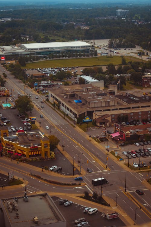 An aerial view of a city street with cars and buildings