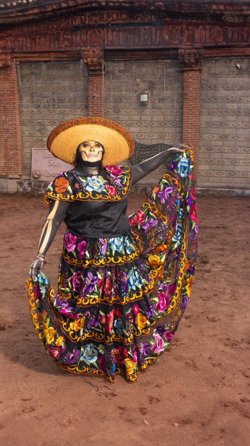 Free A colorful Catrina with intricate makeup and traditional dress celebrating Dia de los Muertos. Stock Photo