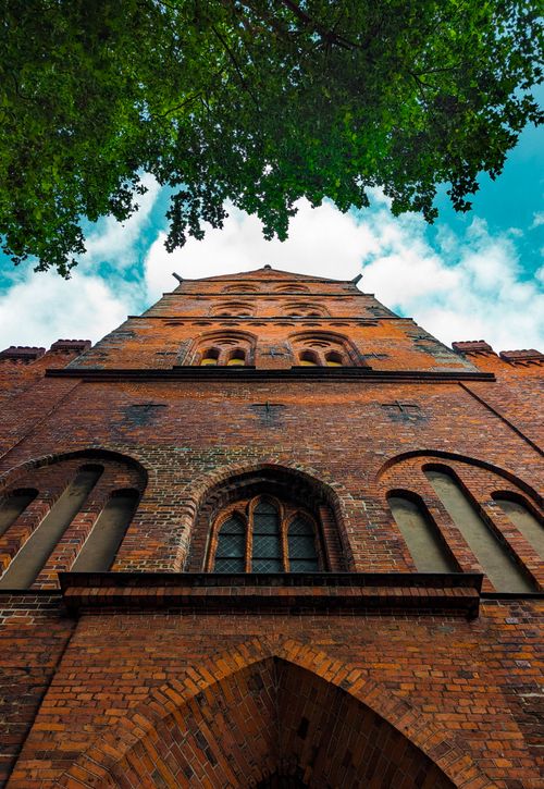 Free Dramatic view of a Gothic brick church facade in Lübeck, Germany, showcasing architectural details. Stock Photo