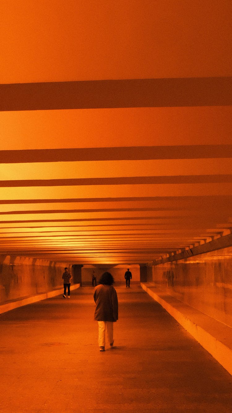 People Walking In Tunnel