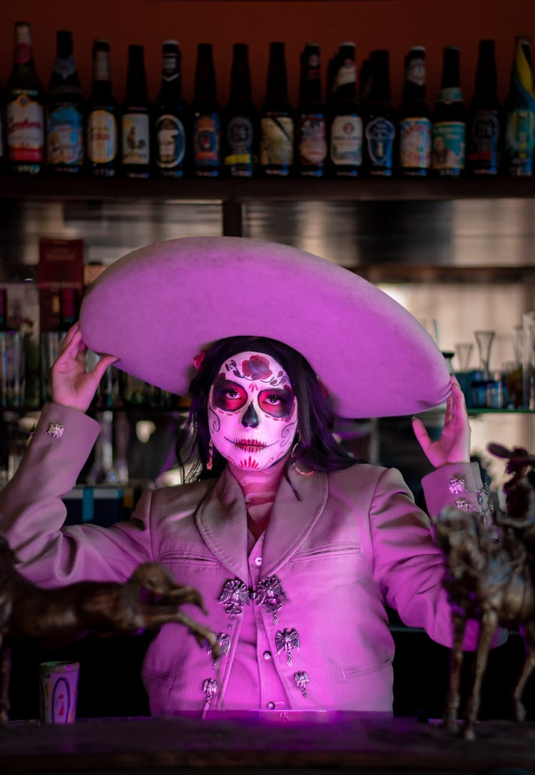 Woman Wearing Costume Of La Calavera Catrina In Bar