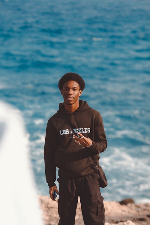 Man in Hoodie by Sea