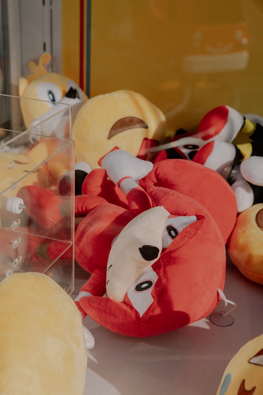 Bright orange soft-toy foxes stacked in a display case. Photo by Elina Volkova on Pexels