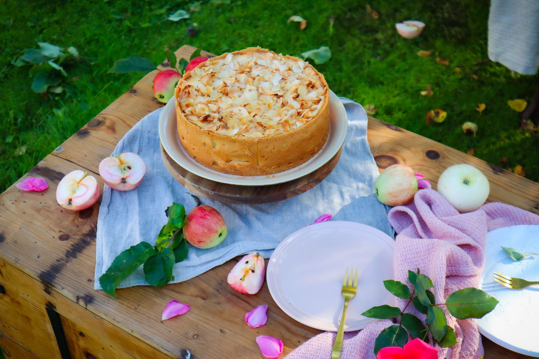 Whipped cream being spread on coconut cream pie