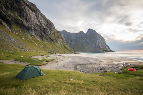 무료 바다를 직면하는 녹색 잔디 필드에 녹색 텐트 스톡 사진