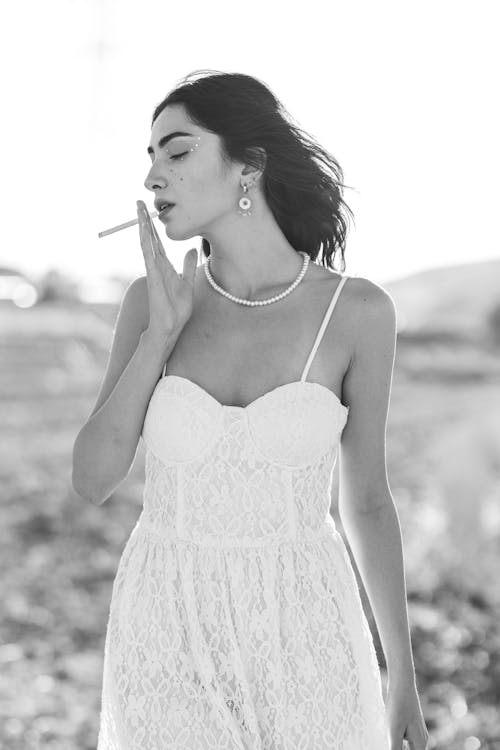 Brunette Woman in Sundress and with Cigarette