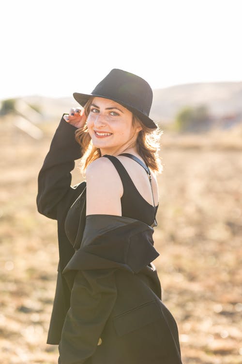 Young Woman Posing in Black Fedora Hat, Strap Dress and Blazer