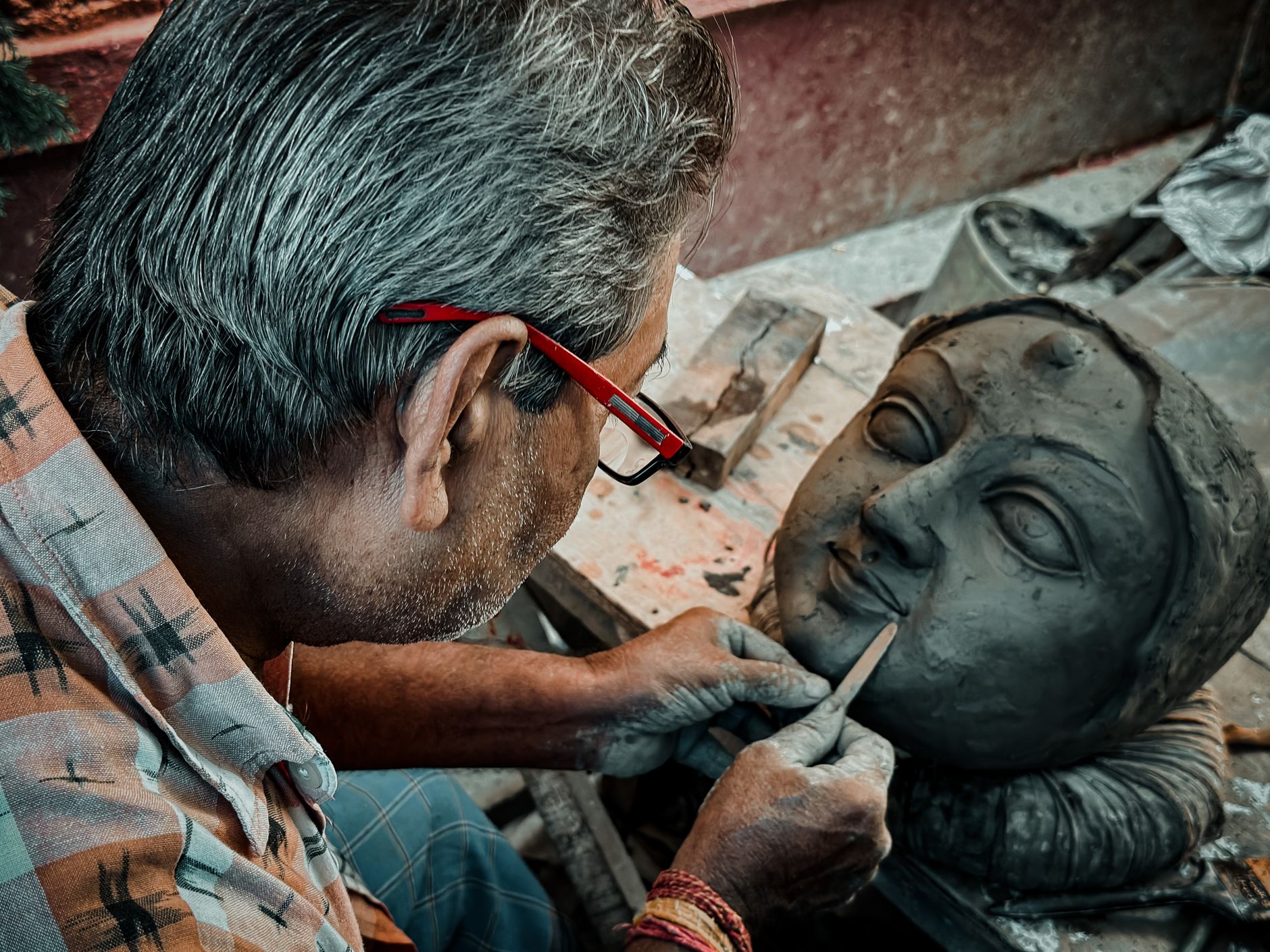 Artisan crafting a clay Ganesha idol