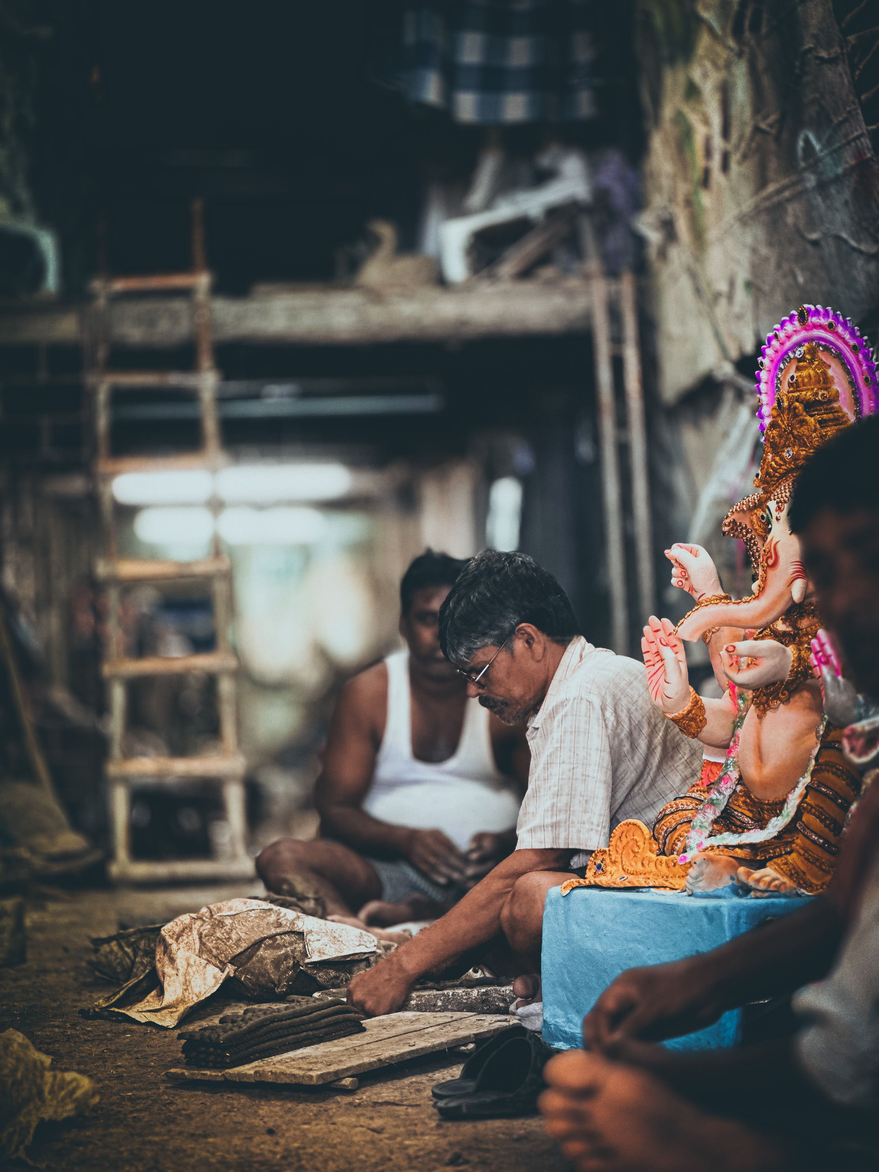 Artisan crafting near a Ganesha idol — photo by Chandan Kumar on Pexels