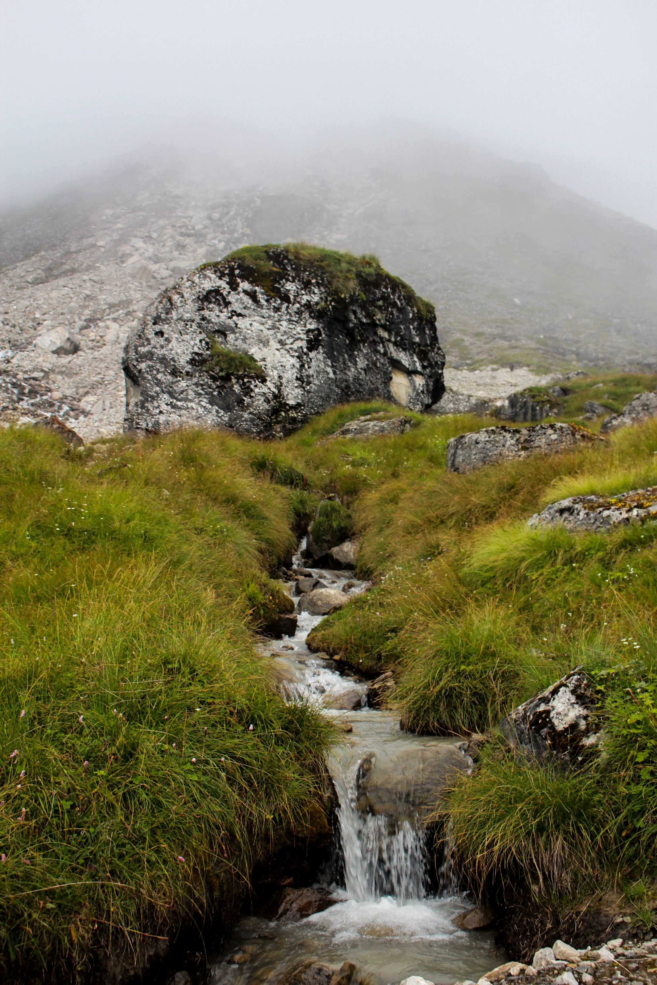 Stream Flowing From Under a Large Boulder on the Mountain Slope · Free ...