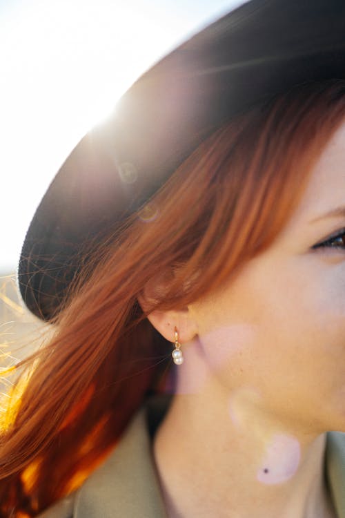 Red Haired Woman Wearing a Black Fedora Hat