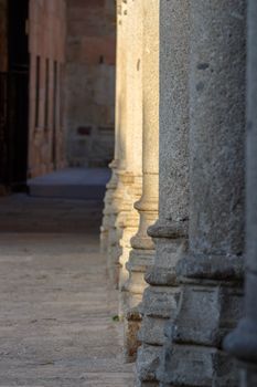 A row of stone columns in an urban architectural setting with natural light.