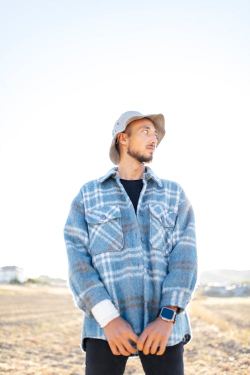 Man in Hat and Jacket on Field