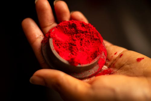 Red Powder in Woman Hand